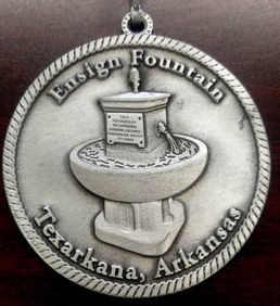 Medal of the Ensign Fountain in Texarkana, Arkansas. Silver with raised relief of fountain and text.