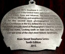 Medallion commemorating Texarkana, a city split between Texas and Arkansas. It highlights landmarks and historical information.
