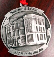 Silver ornament of the Rialto-Harrell Building at 317 N. State Line Ave. with a red hanging loop.