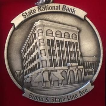 Medal featuring a building labeled 