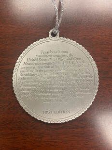 Silver medallion with text, 