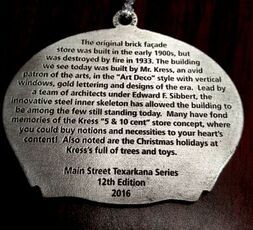 A silver Christmas ornament with text about the history of the Kress 