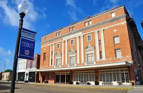 Brick building with white columns, a banner reading