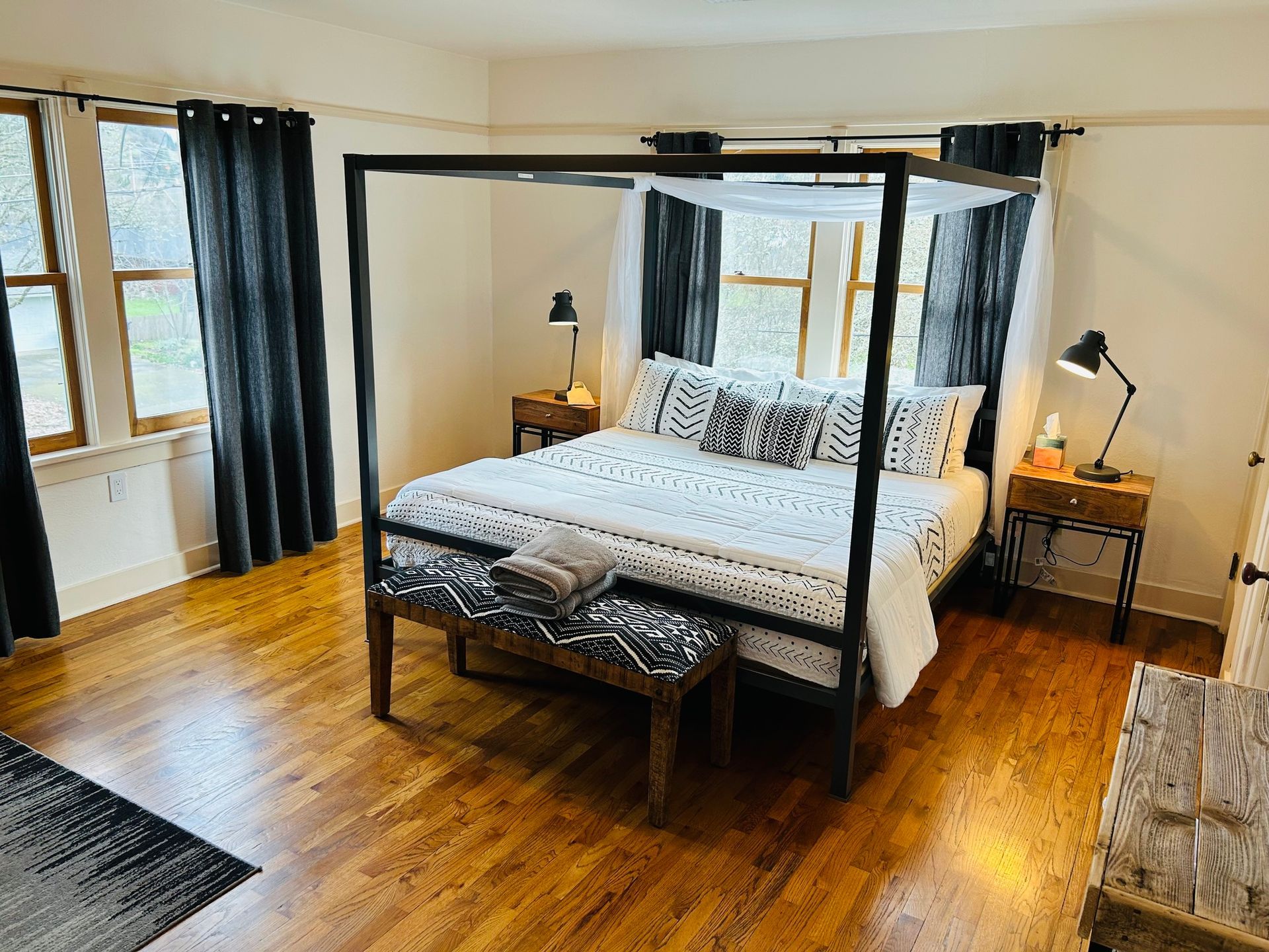 There is a four poster bed in the middle of the room.