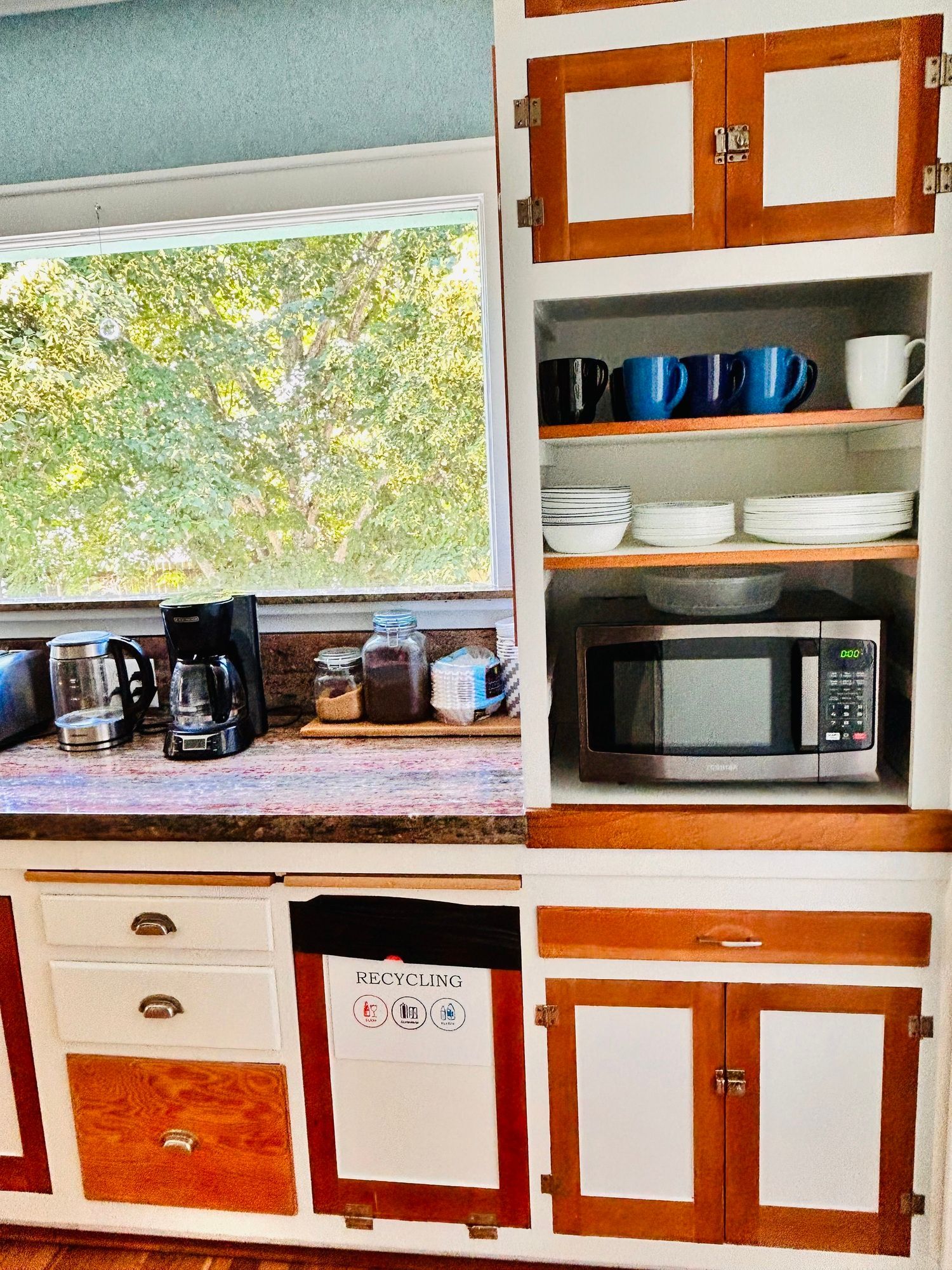 A kitchen with a microwave and a coffee maker