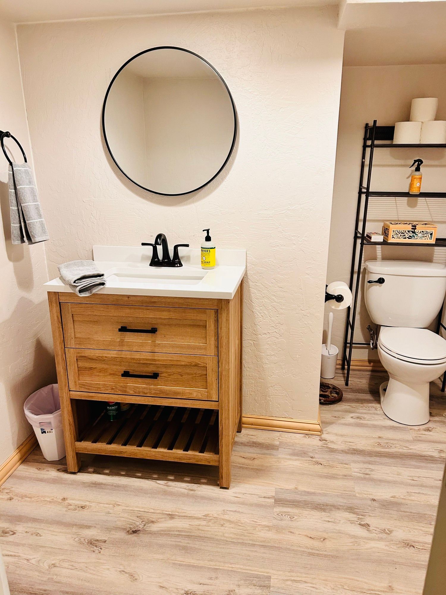 A bathroom with a sink , toilet and mirror.
