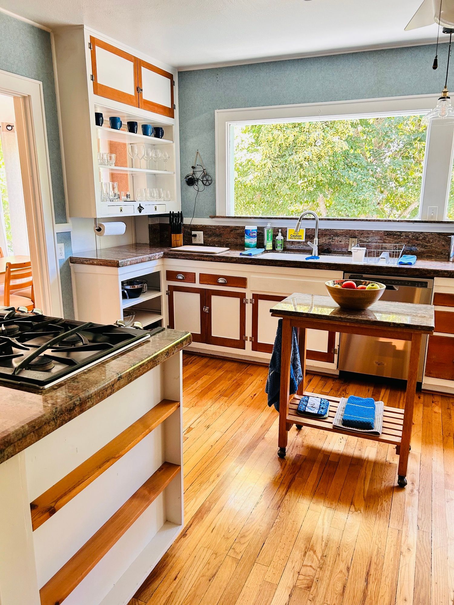 A kitchen with wooden floors and a stove top oven