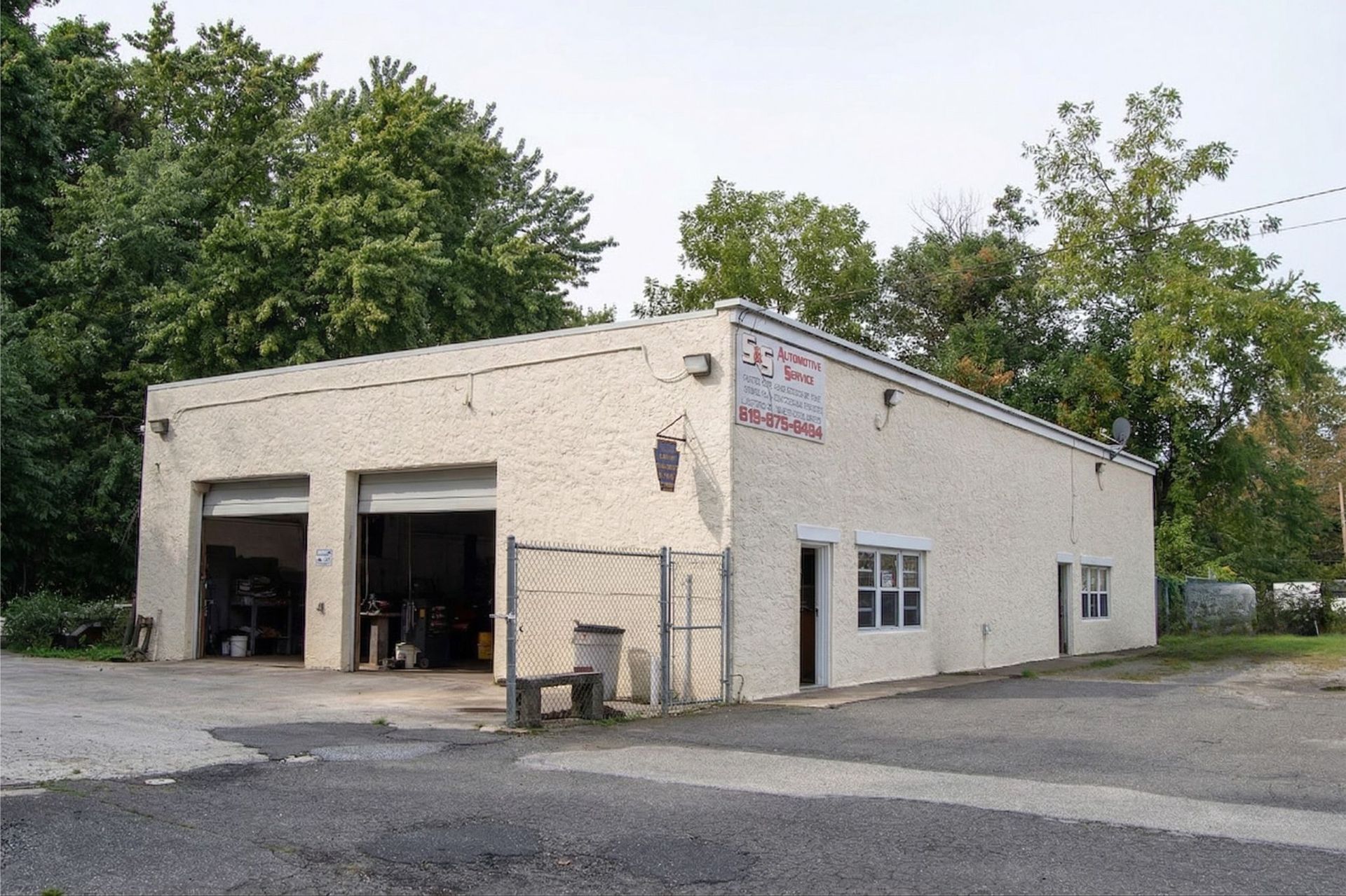 Photo of S&S Automotive Service in Upland PA's one-story auto repair shop with open garage bays.