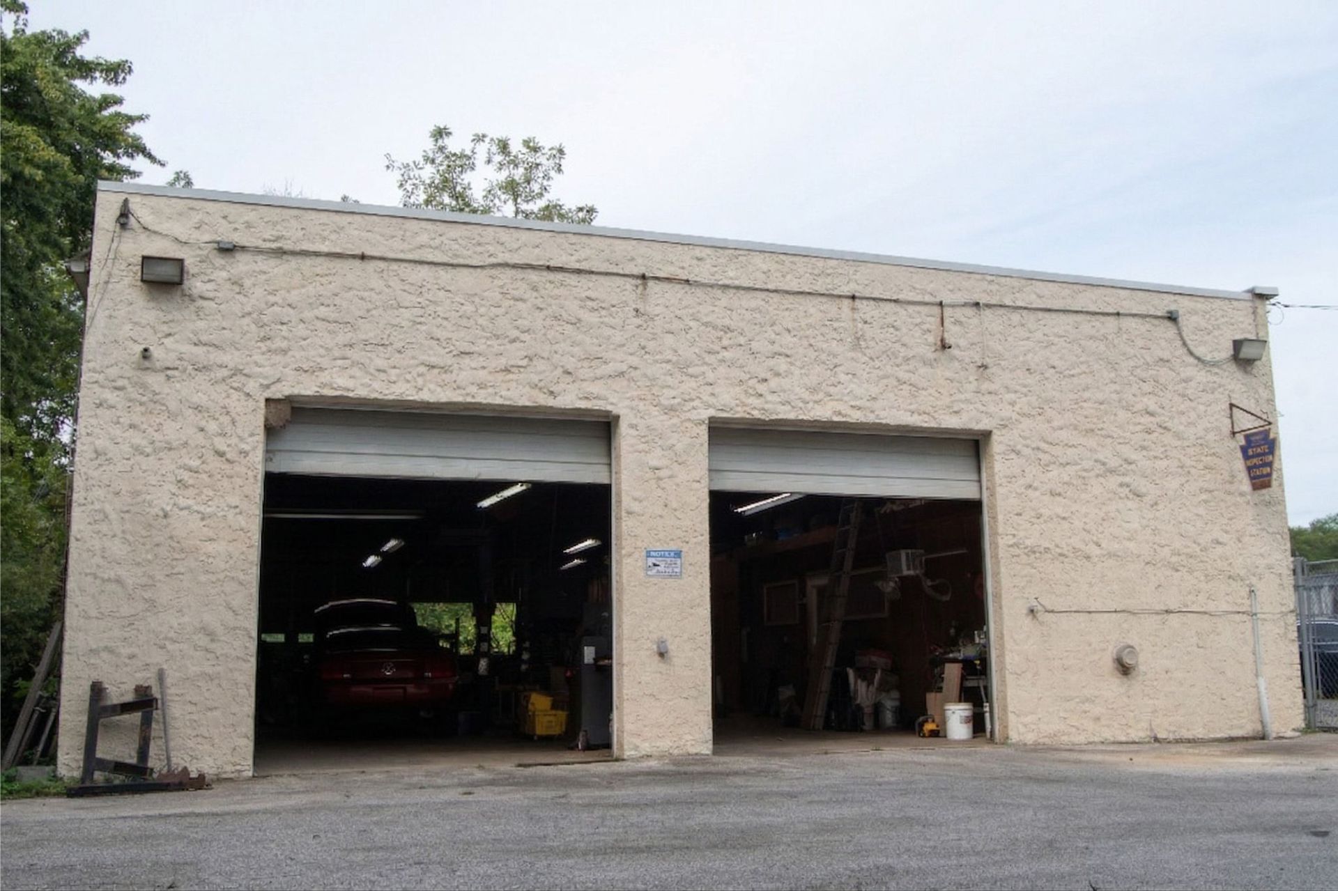 S&S Automotive Service garage in Upland, PA with open doors, stucco exterior, parked car inside.