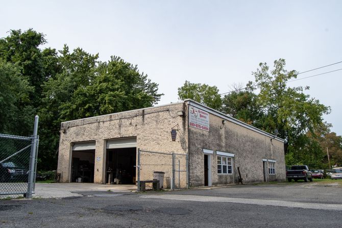 Exterior view of a S&S Automotive Services shop in Upland, PA with two garage doors open.