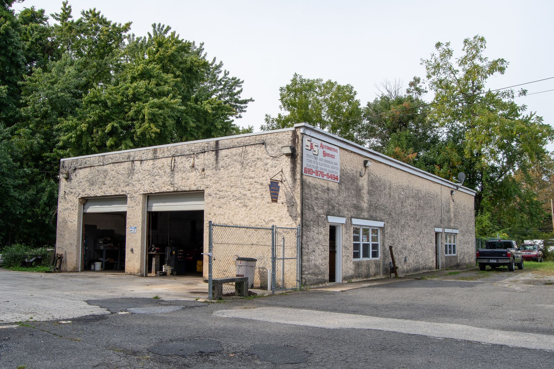 Photo of S&S Automotive Service in Upland PA's one-story auto repair shop with open garage bays. 