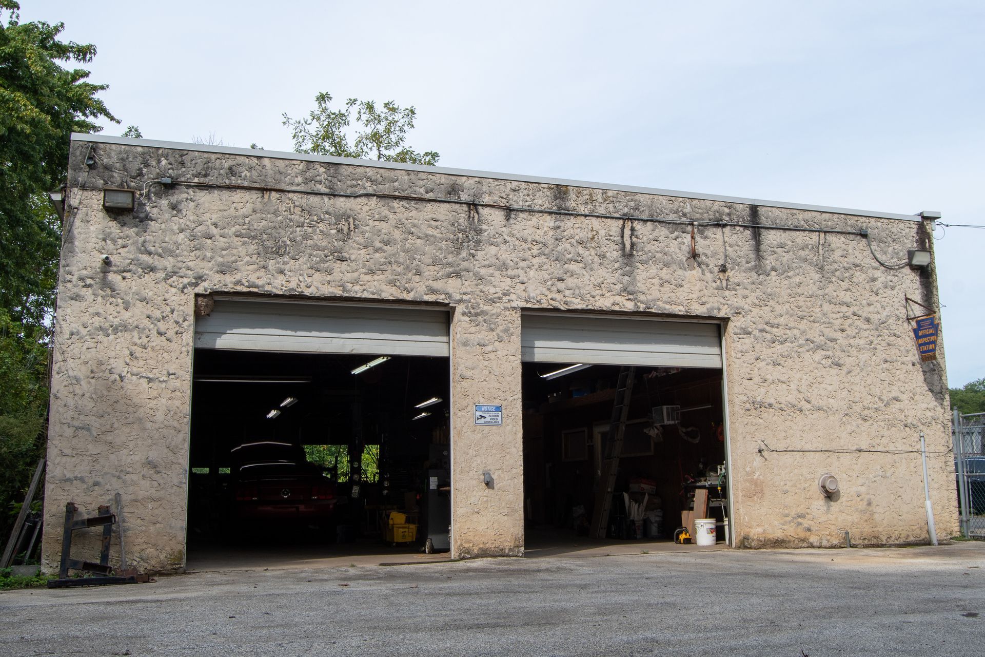 S&S Automotive Service garage in Upland, PA with open doors, stucco exterior, parked car inside.