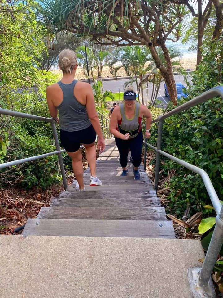Two women are walking up a set of stairs — Maxenergy Fitness In Smithfield, QLD