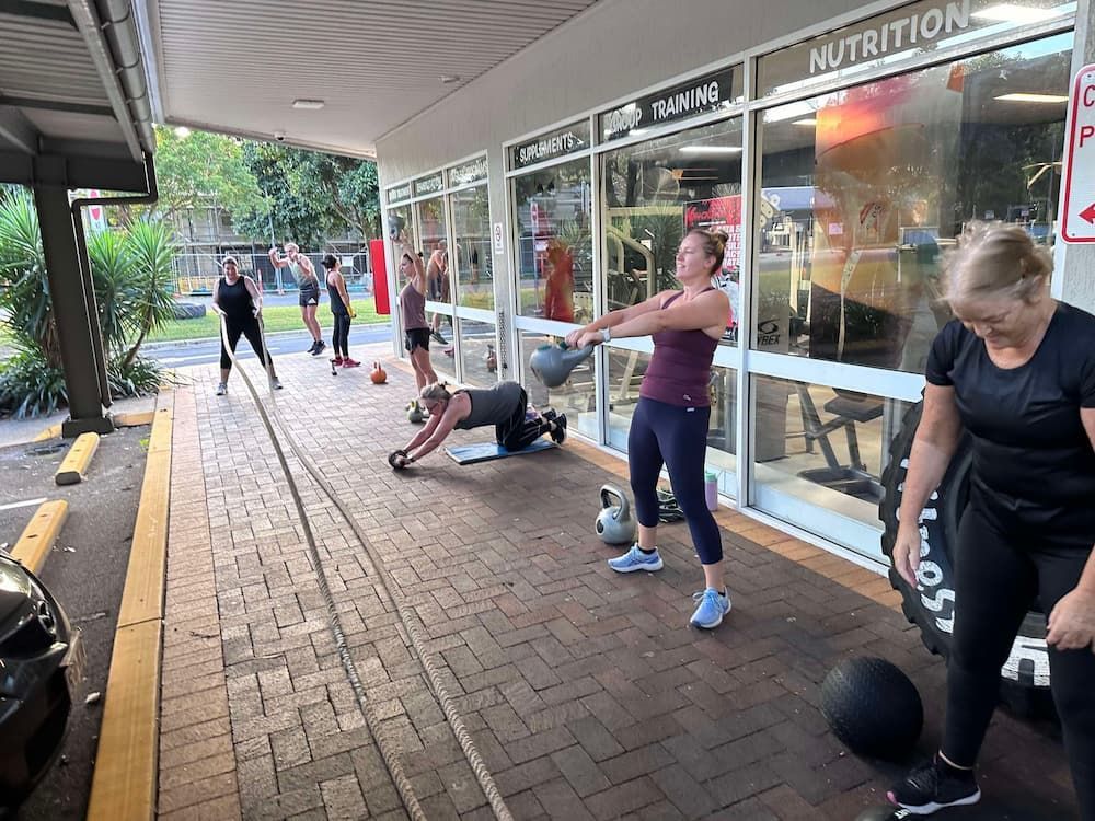 A Group Of People Are Doing Exercises Outside Of A Gym — Maxenergy Fitness In Smithfield, QLD