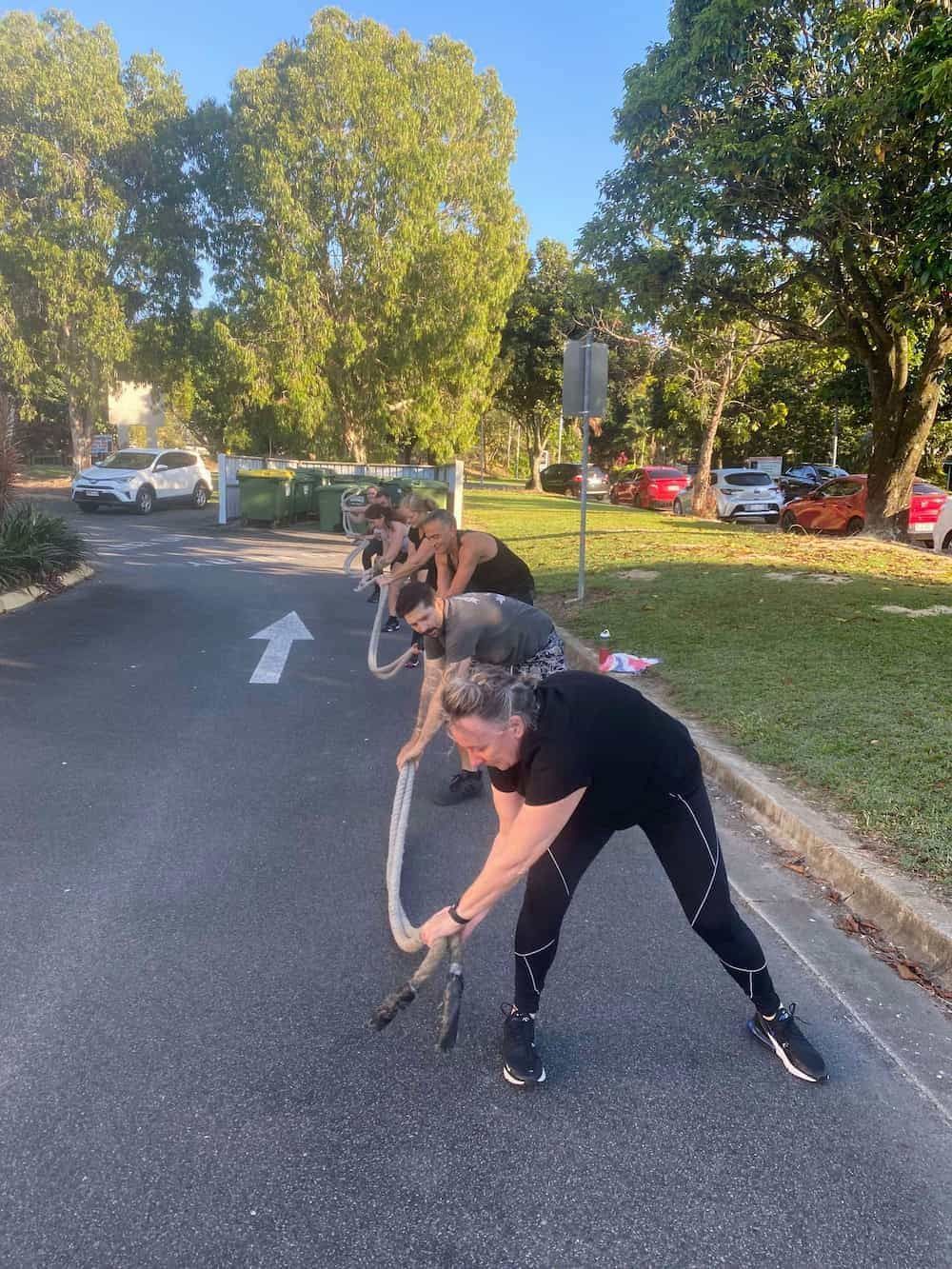A Group Of People Are Doing Exercises On The Side Of The Road — Maxenergy Fitness In Smithfield, QLD