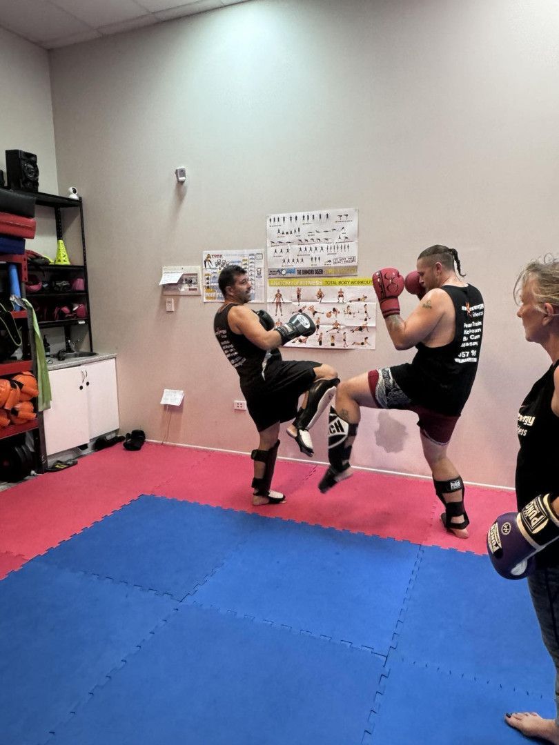 Two Men Are Boxing in a Gym With One Wearing a Black Tank Top — Maxenergy Fitness in Smithfield, QLD