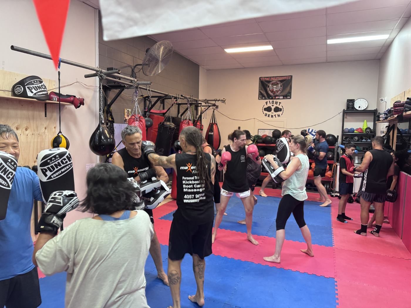 A Group Of People Boxing in a Gym on Blue & Red Mats — Maxenergy Fitness in Smithfield, QLD