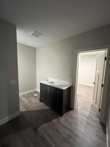 A bathroom with a sink and a dresser in it.