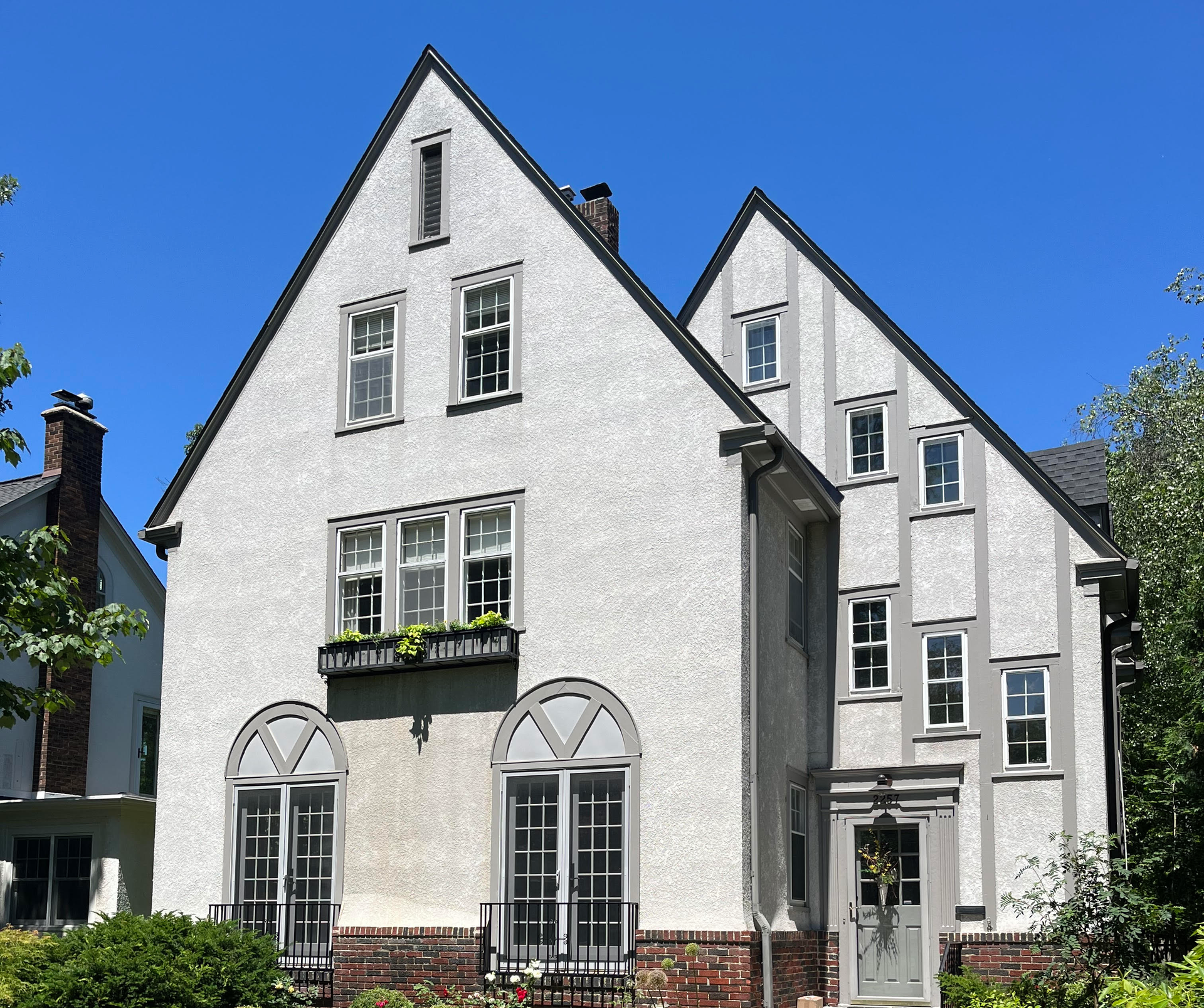 A large white house with a blue sky in the background