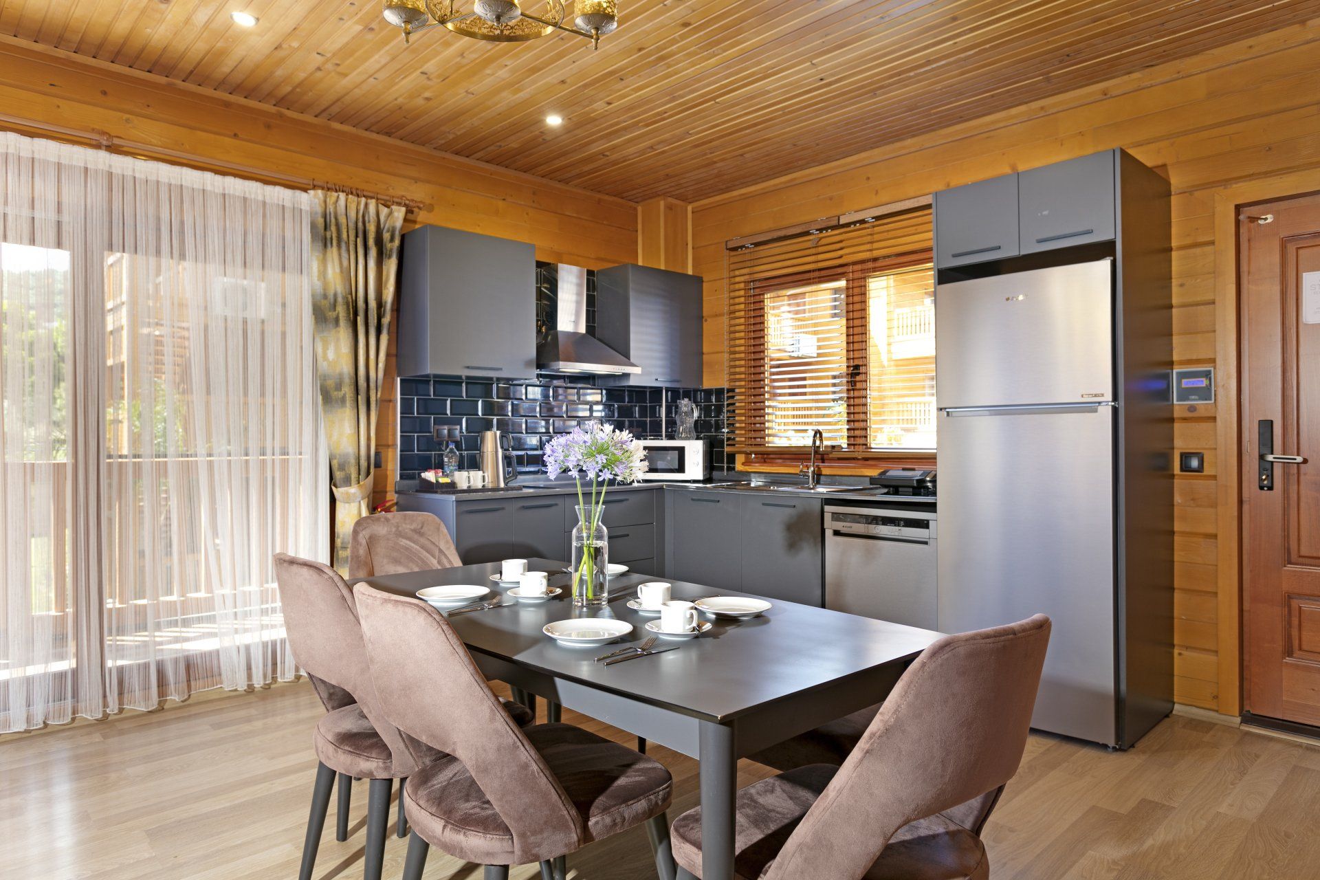 مطبخ وغرفة طعام في منزل خشبي مع طاولة وكراسي.