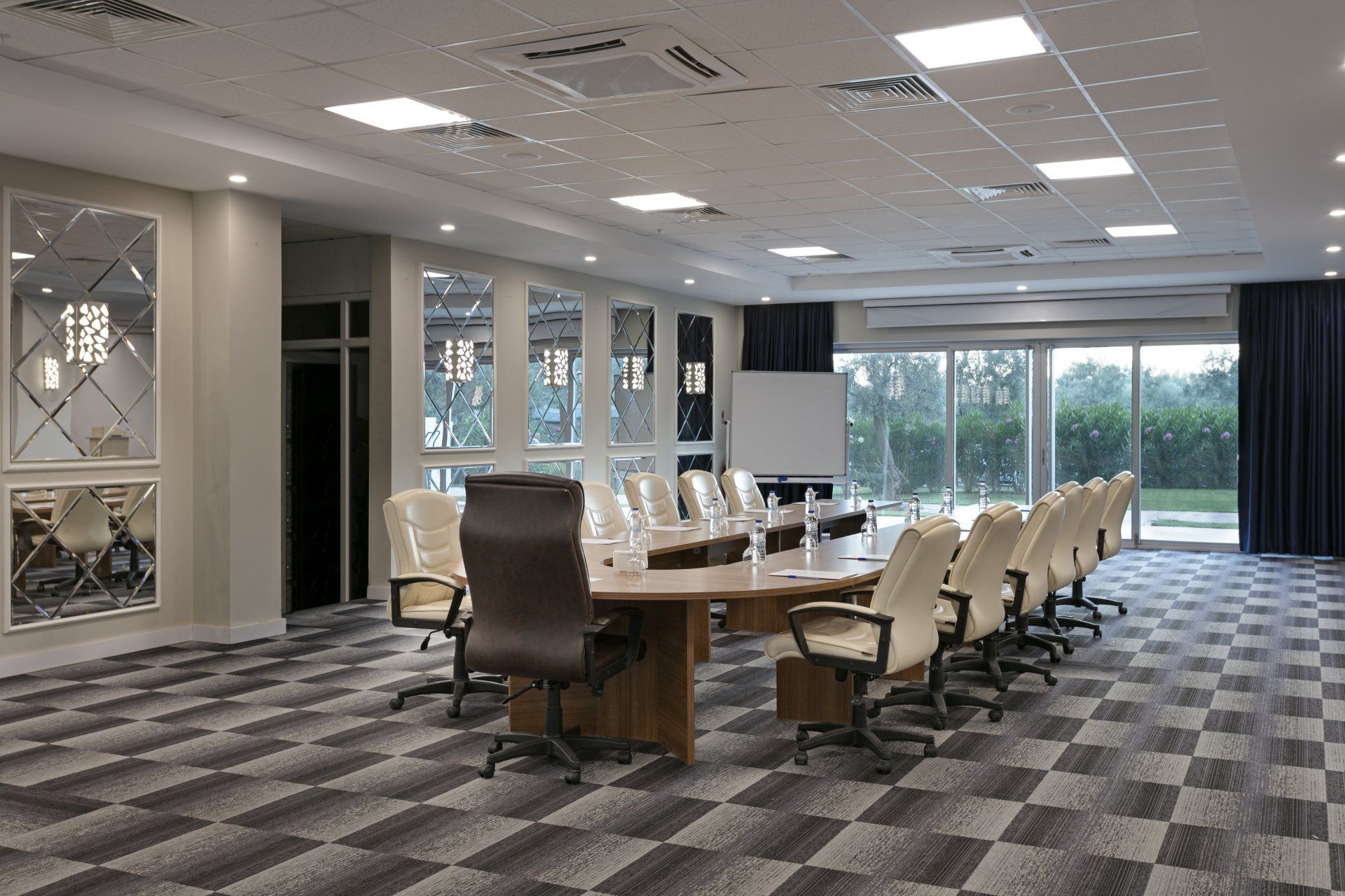 A large conference room with a long table and chairs.