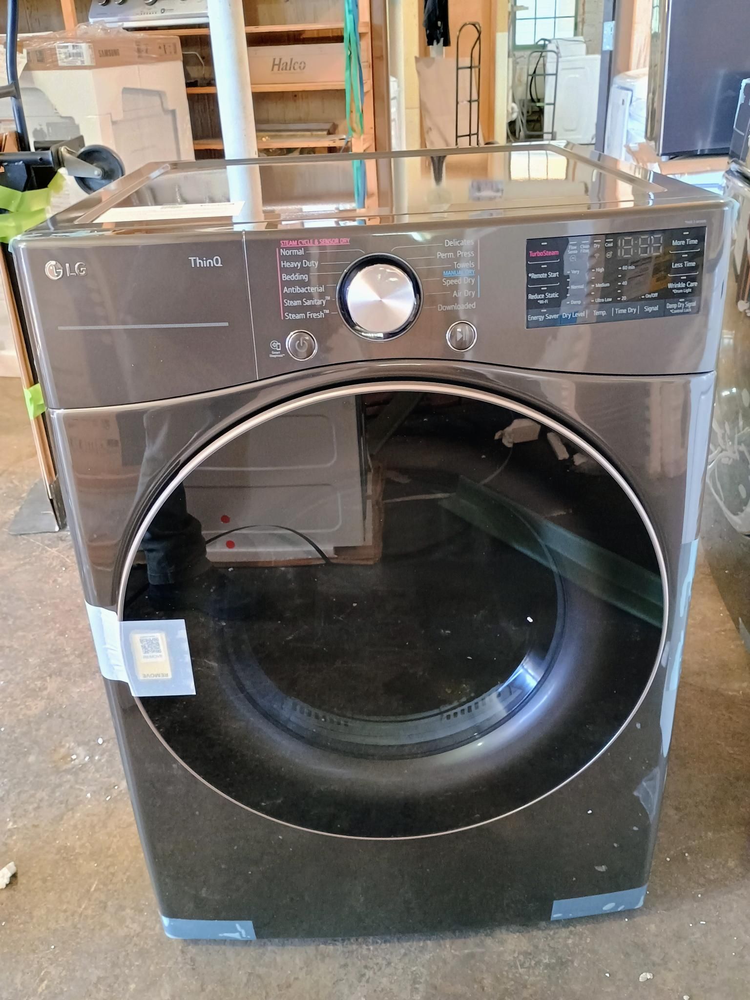An lg washer and dryer is sitting on the floor in a room.