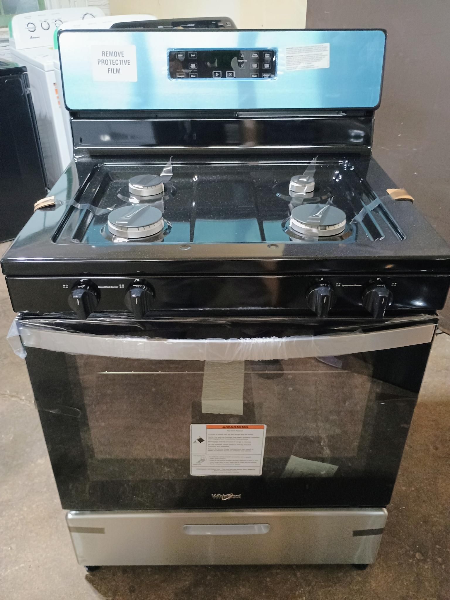 A black gas stove with a stainless steel oven