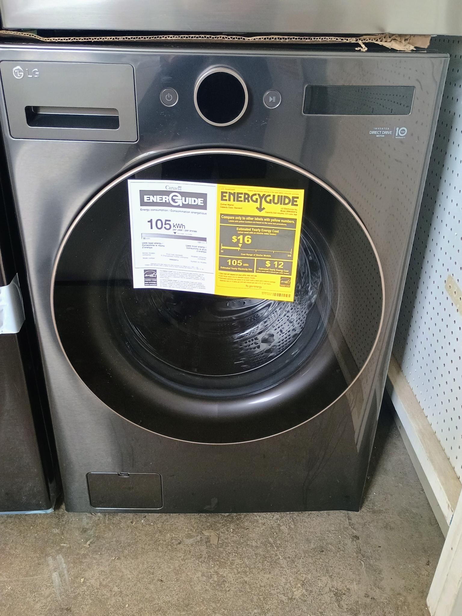 A black washing machine with a yellow energy guide label on it.