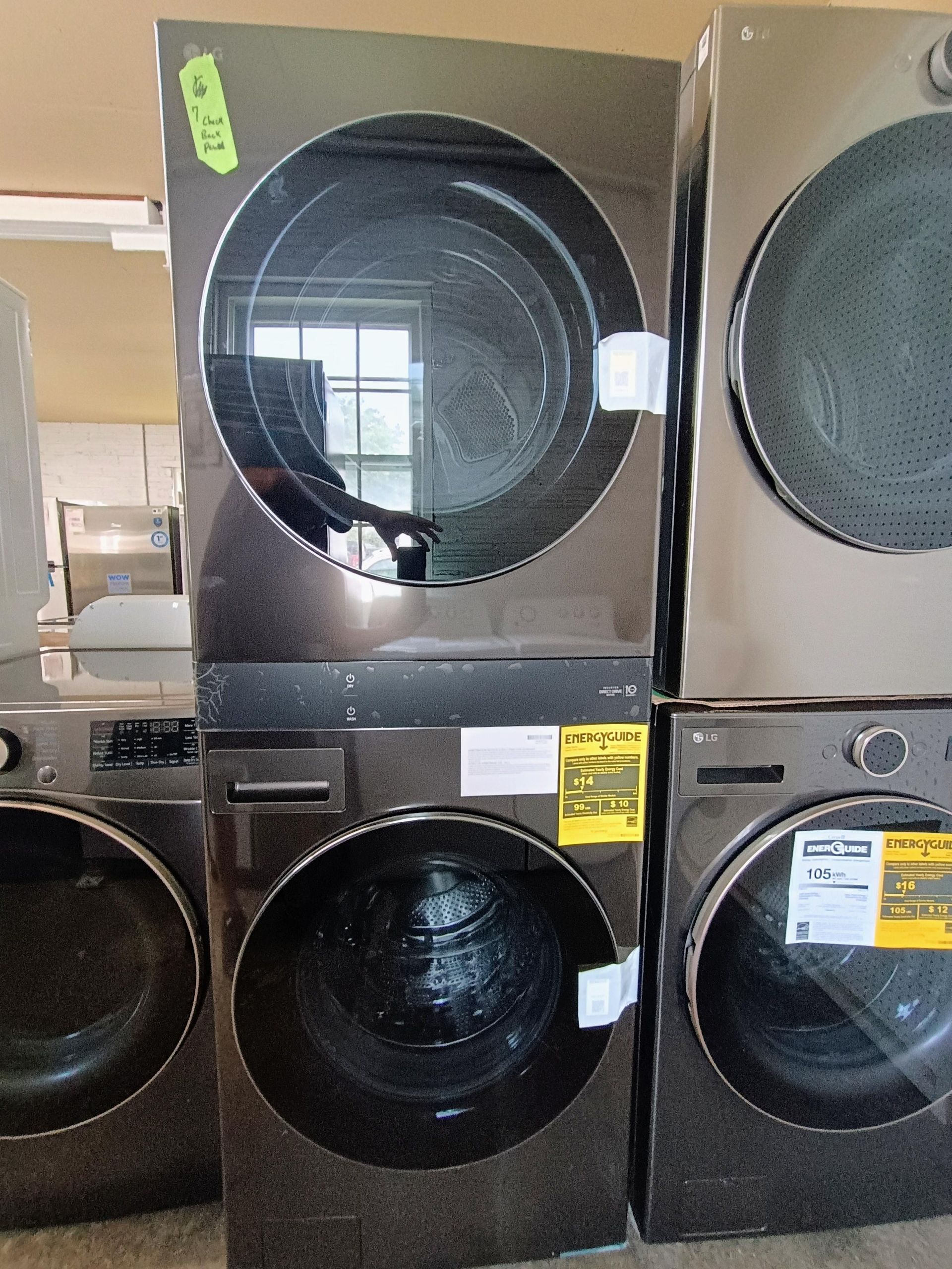 A stack of washers and dryers are sitting on top of each other.