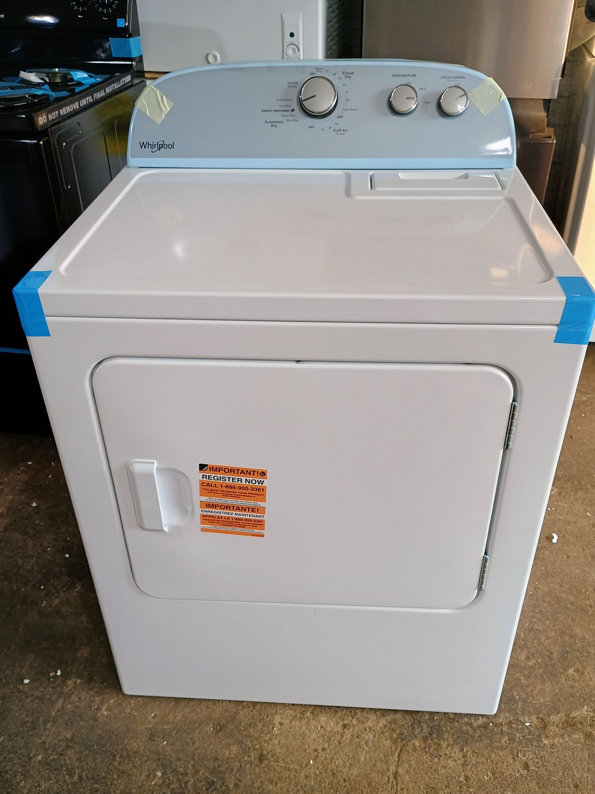 White electric dryer with light blue control panel and door.