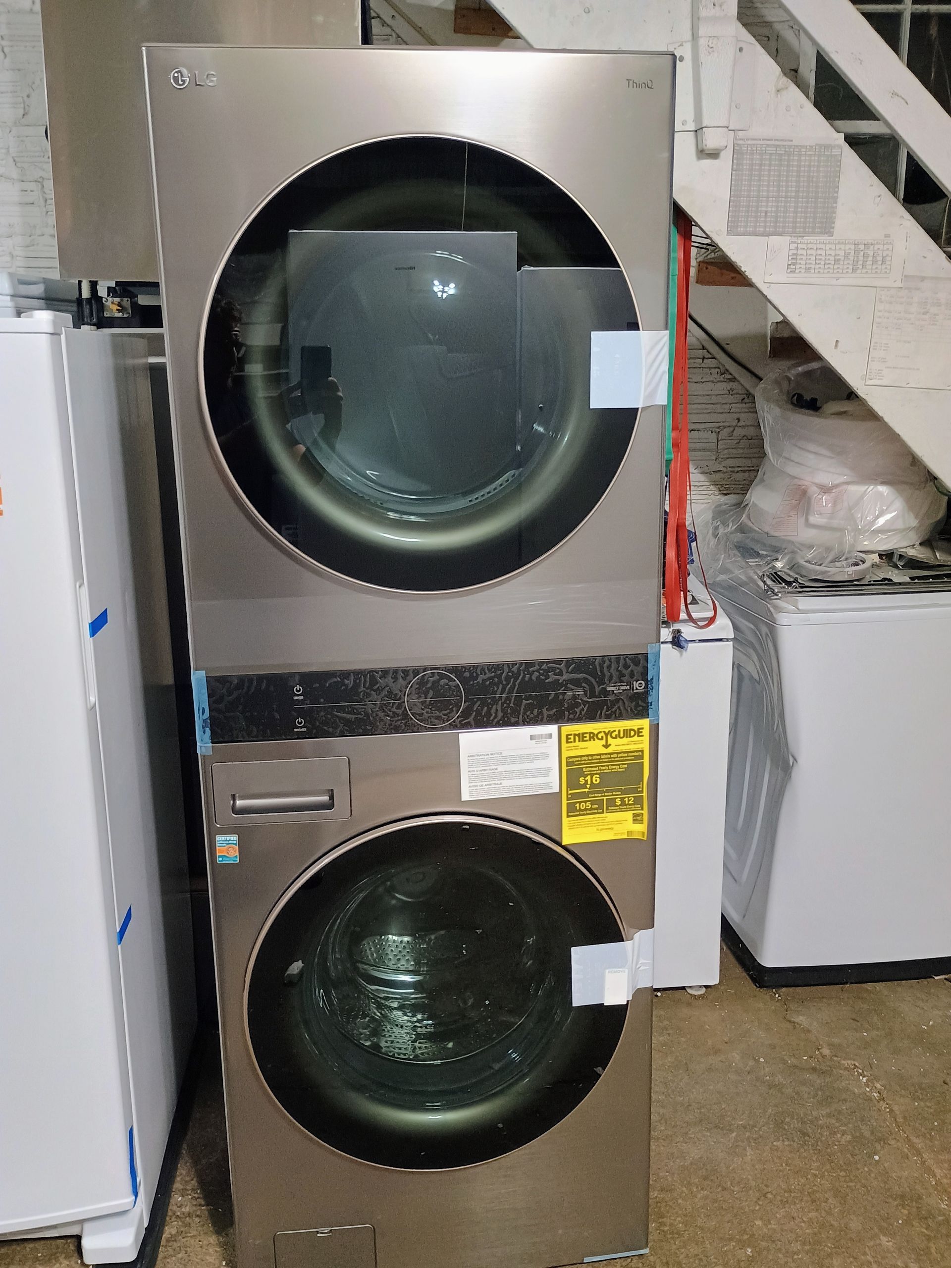 Stacked stainless steel washer and dryer with large round glass doors.