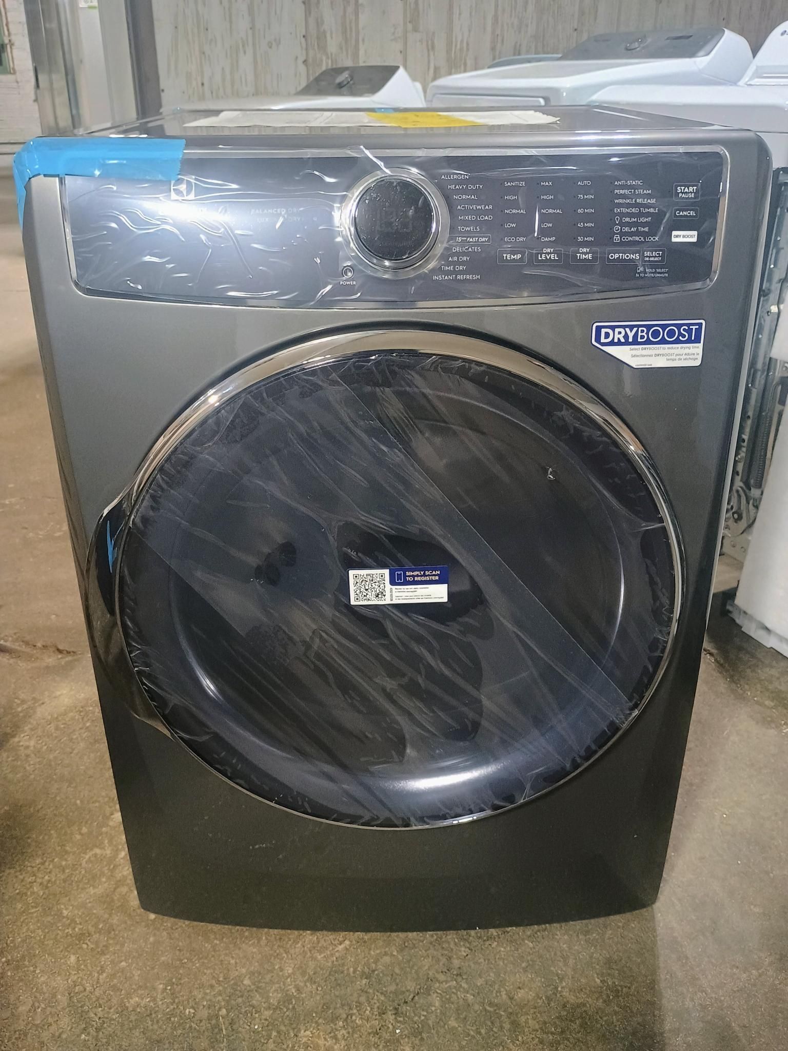 Dark gray front-load washing machine with a large, round black door.
