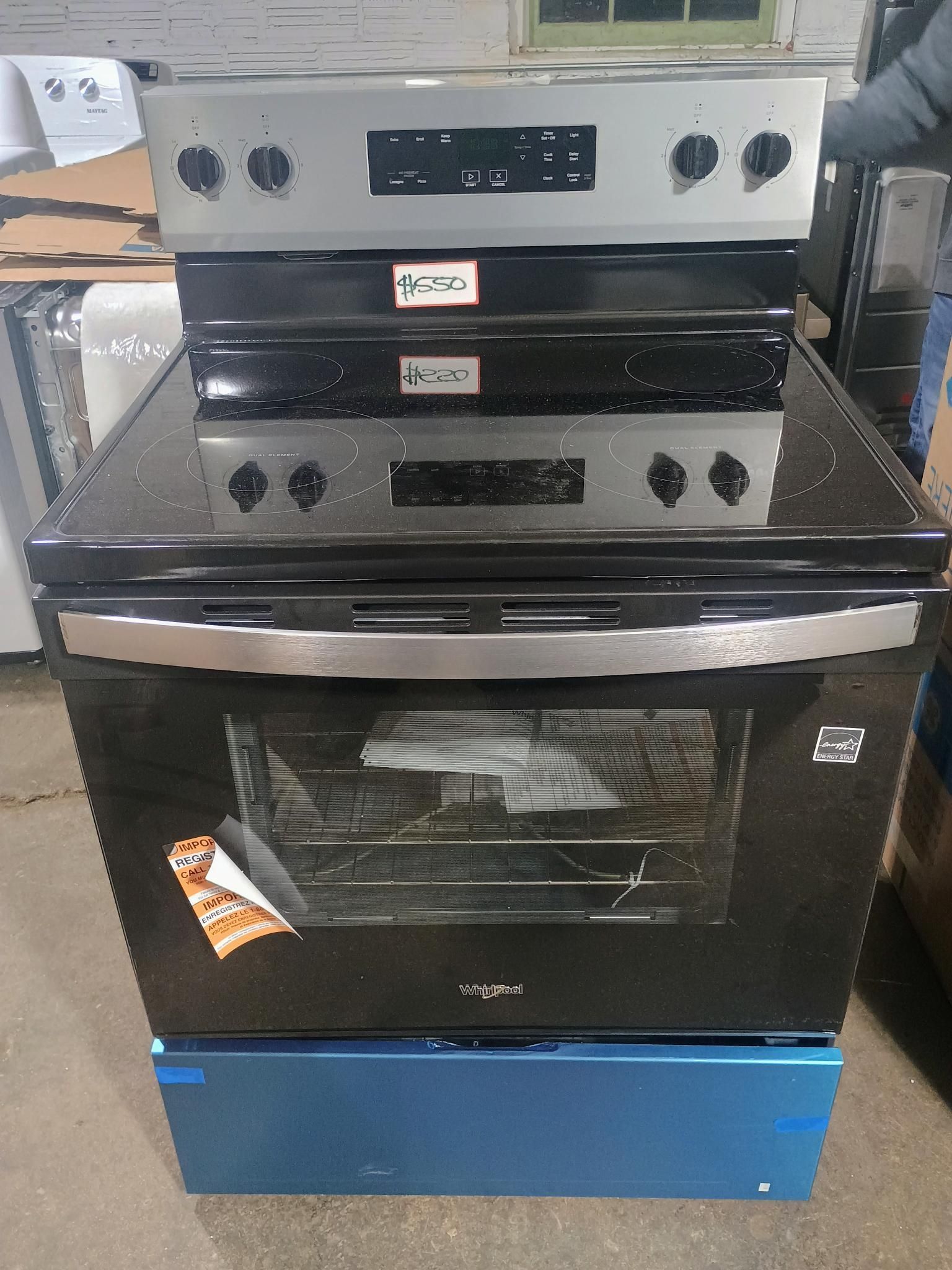 Black and stainless steel electric range with glass cooktop and oven.