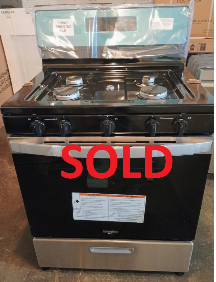 A whirlpool gas stove is sitting on the floor