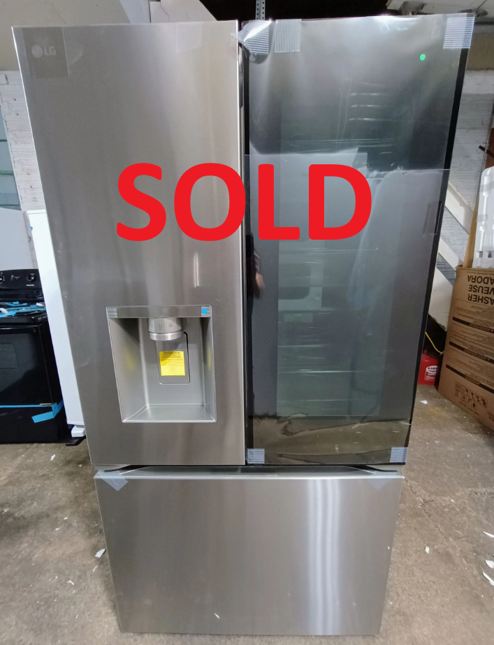 Stainless steel LG refrigerator with water dispenser and glass door.