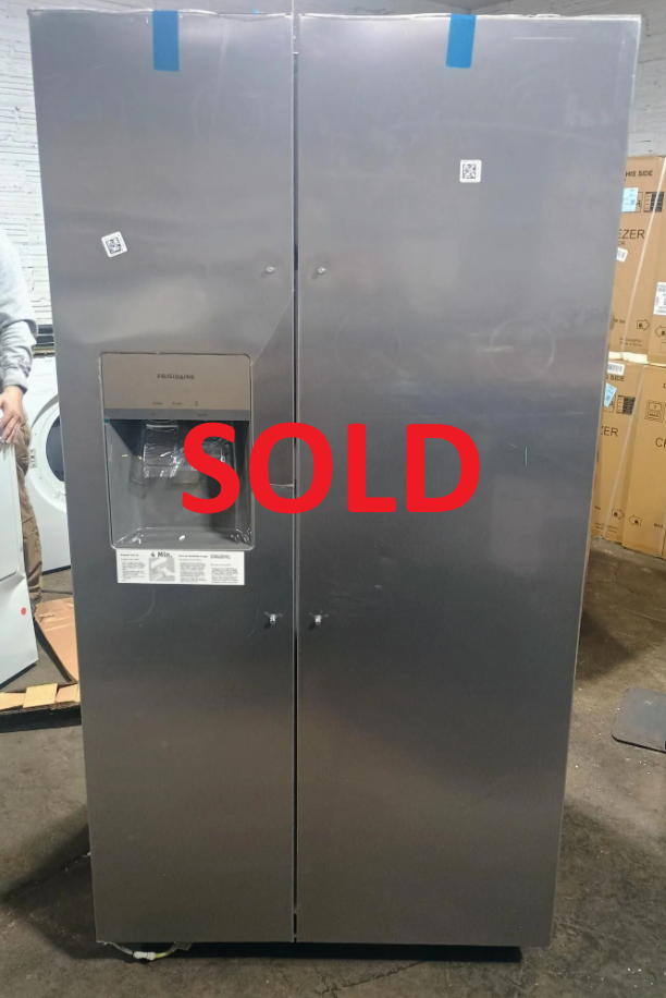 Stainless steel side-by-side refrigerator with water/ice dispenser, indoors.