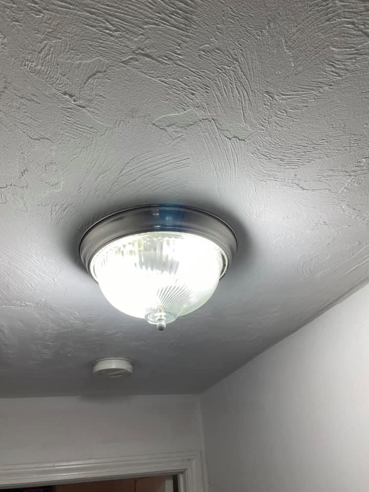 A light fixture is hanging from the ceiling of a room.