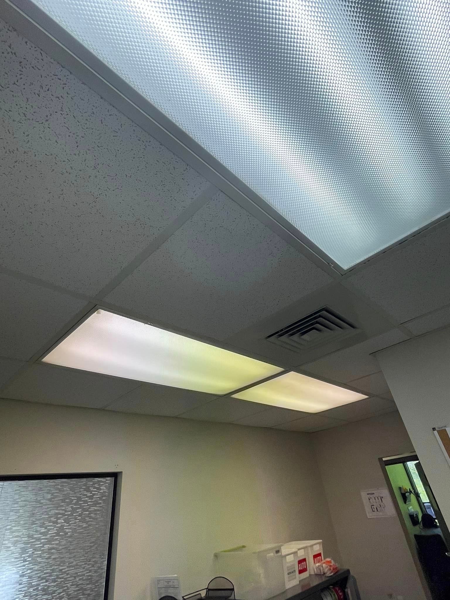 A room with a ceiling that has a lot of lights on it.