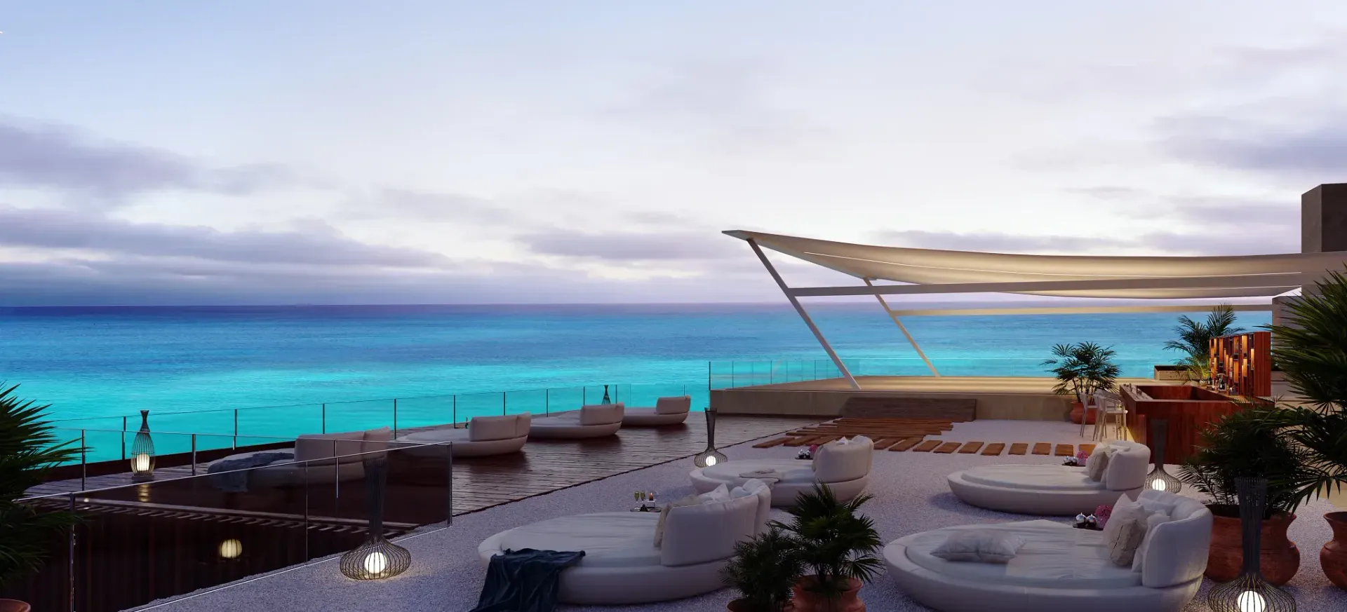 Rooftop lounge overlooking turquoise water and cloudy sky. White couches and potted plants.