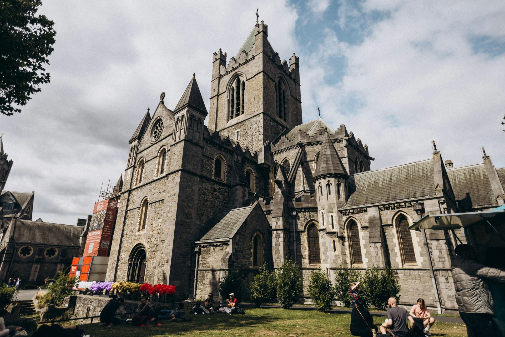 Exterior view of Christ Church Cathedral in Dublin, Ireland, with stone facade and cloudy sky.
