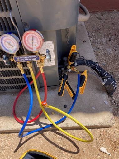 A close up of a refrigerator with hose attached to it.