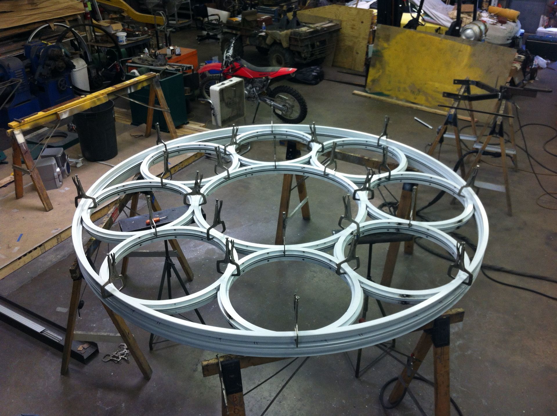 A circular piece of metal is sitting on a table in a workshop