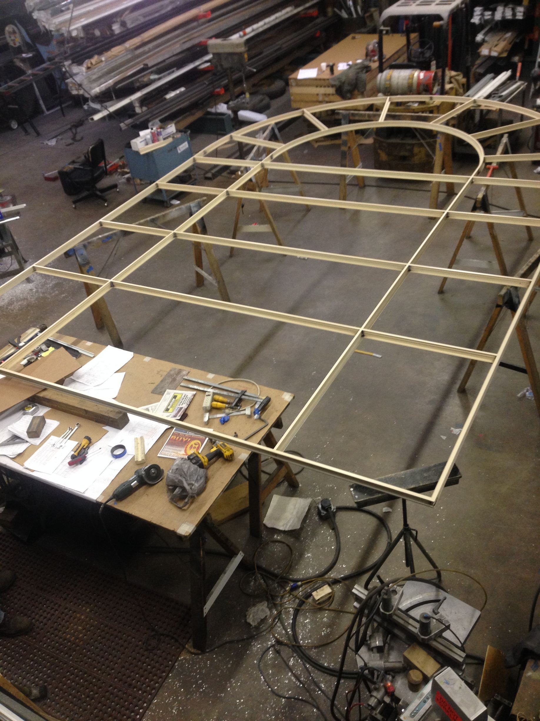 A wooden frame is being built in a workshop.