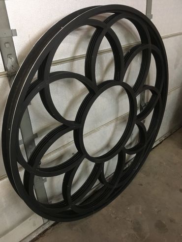 A black circular object is sitting on a garage door.