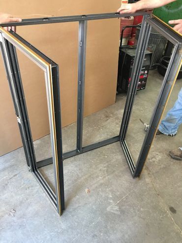 A person is measuring a window frame with a tape measure.