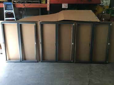 A row of metal frames sitting on top of each other in a garage.