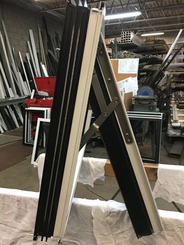 A black and white piece of metal is sitting on a table in a warehouse.