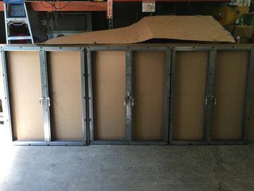 A large piece of cardboard is sitting on top of a metal cabinet.