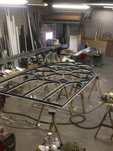 A large piece of metal is sitting on top of a table in a workshop.