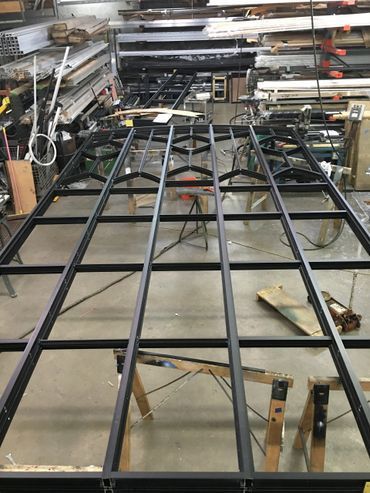A metal frame is being built in a workshop.
